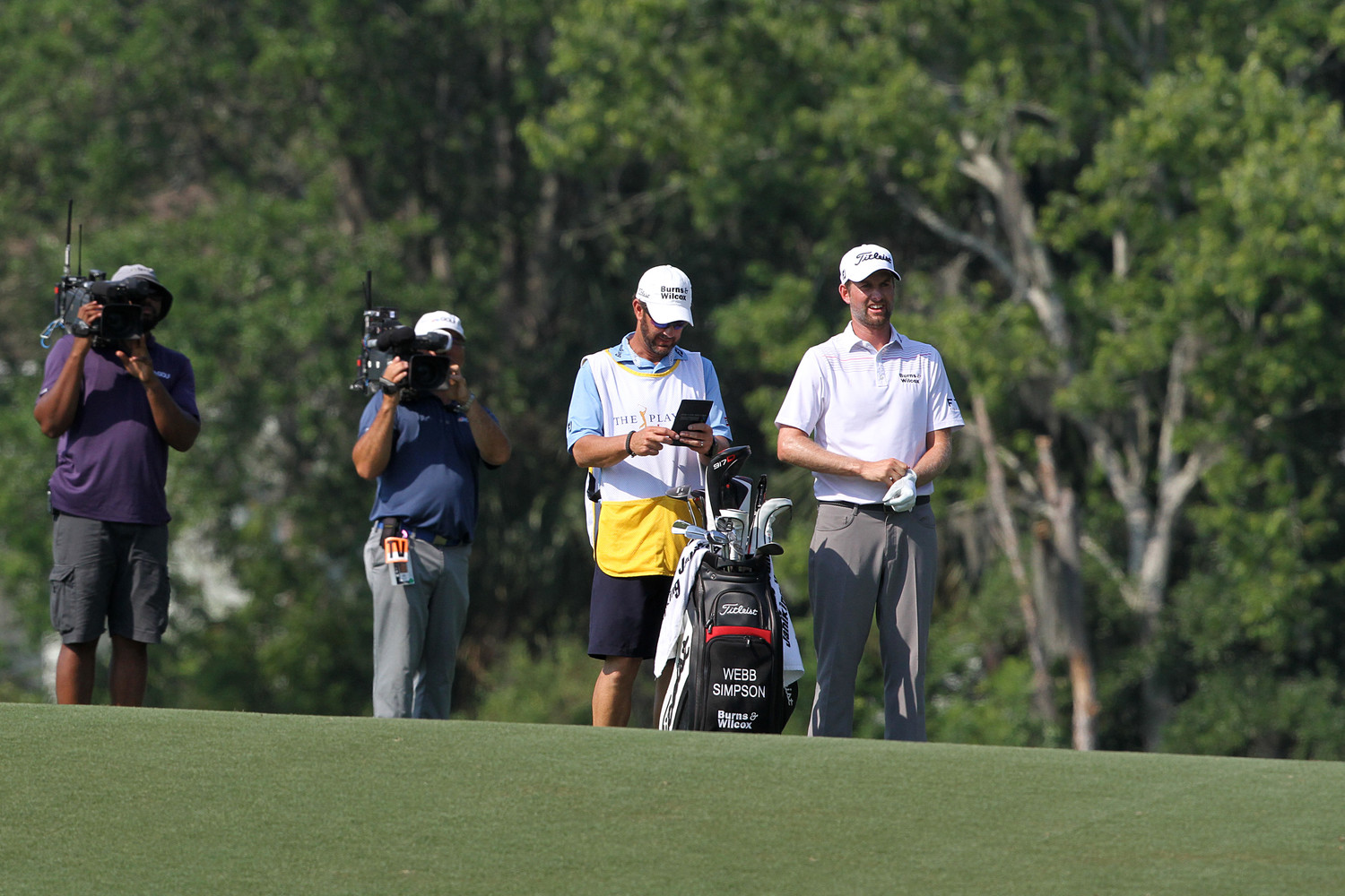 Paul Tesori, the caddie for THE PLAYERS Championship 2018 winner Webb Simpson and a Nocatee resident, surveys the field with Simpson during the final round of the tournament.